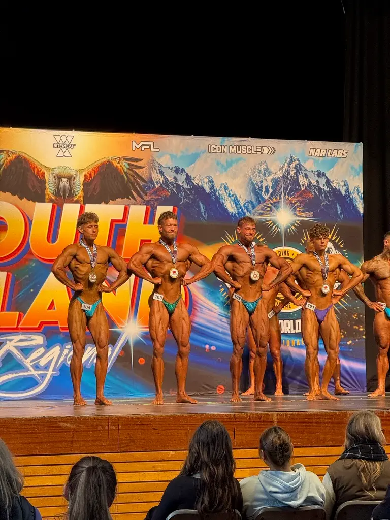 Team Ecroyd athletes on stage with medals at the South Island Regional